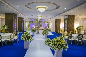 a banquet hall with tables and chairs and flowers at Alya Hotel & Suites Ltd in Nairobi +45 photos
