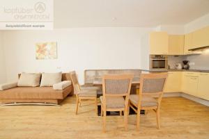 a living room with a table and chairs and a couch at Alpenperle in Ischgl +20 photos
