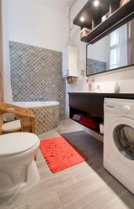 a bathroom with a toilet and a washing machine at Downtown Rising Sun 104 sq.m in Budapest