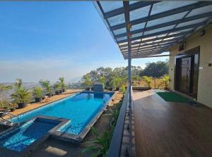a swimming pool in the middle of a house at Navishka'S Villa in Panchgani