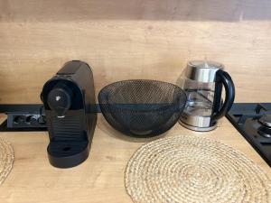 a black mixer sitting on top of a counter at ALiVA Stay Apartment in Craiova