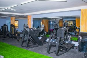 a gym with tread machines and green grass at Alya Hotel & Suites Ltd in Nairobi