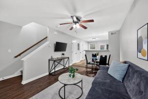 a living room with a couch and a ceiling fan at Inviting 2BR hideaway with contemporary touches in Clarksville