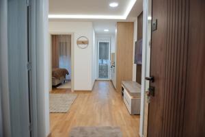 a hallway with a room with a bed and a door at Phenix Apartments Lux Parking FREE in Podgorica