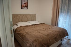 Ένα ή περισσότερα κρεβάτια σε δωμάτιο στο Phenix Apartments