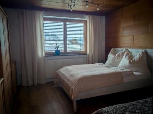 a bedroom with a large bed and a window at Ferienwohnung Doppelreiter in Ebbs +32 photos