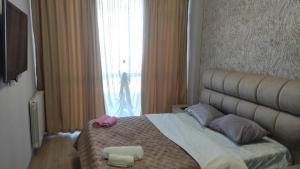 a bedroom with a bed with two towels on it at Tbilisi best view of the river in Tbilisi City