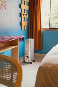 a room with a bedroom with a heater in the corner at Casa privada con vista a las montañas Dona Catta in Ollantaytambo
