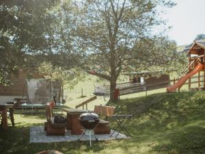 a park with a playground with a slide and a grill at Kirchlehof in Oberried
