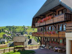 a building with flower boxes on the balconies of it at Kirchlehof in Oberried