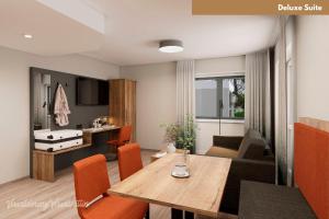 a living room with a table and a dining room at Hotel Zur Post in Ismaning