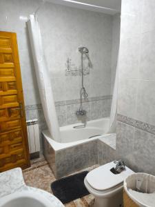 a bathroom with a tub and a toilet and a sink at CASA EL LAUREL in Vélez-Rubio +16 photos