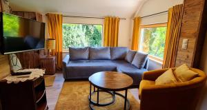 a living room with a couch and a table at Chata w Rabce - Bajkowa Osada in Rabka