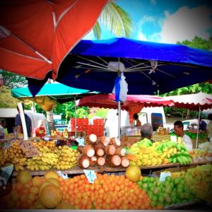 a market with a bunch of fruits and vegetables at La Varangue bleu T3 Aéroport Sainte Marie in Sainte-Marie