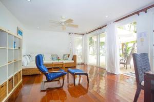 a living room with a couch and a table and chairs at Right along the shoreline ! in Boracay