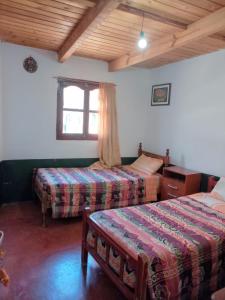 Ένα ή περισσότερα κρεβάτια σε δωμάτιο στο HOSTAL LUPITA