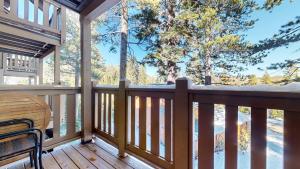 a screened porch with a table and a chair on it at Western Slopes Villas #7 condo in Mammoth Lakes