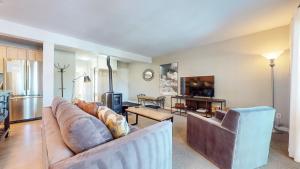 a living room with a couch and a tv at Western Slopes Villas #7 condo in Mammoth Lakes