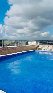 a large blue swimming pool on top of a building at Alya Hotel & Suites Ltd in Nairobi