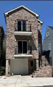 a brick house with a staircase and a garage at Peace Haven Stay in Newark