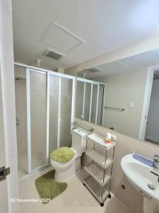 a bathroom with a toilet and a sink at Azure North Bali 26th in Lagundi