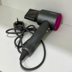 a black hair dryer sitting on a table at Make Memories Escape 2BR Stay Summer Mall in Kota Samarahan