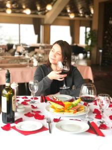 a woman sitting at a table with a glass of wine at Boulevard Side Hotel in Baku +93 photos