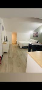 a large room with a bed and a desk at PsApart in Augusta