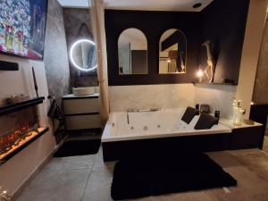 a large bathroom with a tub and a fireplace at la chambre d'hôte de glad et guigui in Rinxent +59 photos