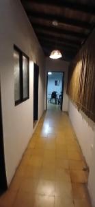 a long hallway with a room with a table at Montanha in San Rafael