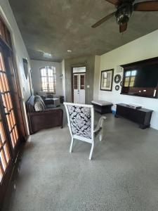 a living room with a couch and a chair at Lavista Antigua in Bats Cave
