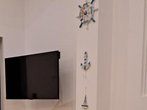 Cactus reef في آهانغاما: جدار فيه تلفزيون وساعة على جدار