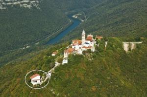 an aerial view of a house on a hill next to a river at Tau Forest Lodge in Solkan