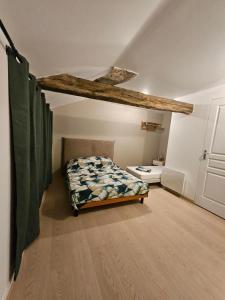 a bedroom with a bed in a room at Murmures de la Risle in Pont-Audemer