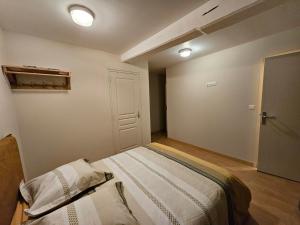 a bedroom with a large bed in a room at Murmures de la Risle in Pont-Audemer