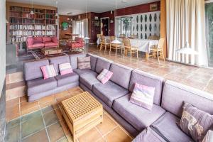 a living room with a couch and a table at Maison Percheronne by Green Folies, 15p & piscine in La Gaudaine