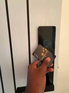a person is holding a wallet in a elevator at Bonthi Grand in Gemanafushi