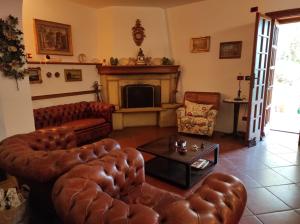 a living room with leather furniture and a fireplace at Rosa dei Venti in Rapallo +20 photos