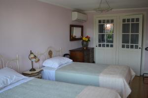 a bedroom with two beds and a door with a window at Porto.arte guest apartments in Porto