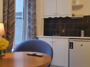 a kitchen with a table and a blue chair at Cosy in Cork in Cork
