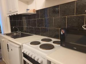 a kitchen with a stove and a microwave at Cosy in Cork in Cork +1 photo