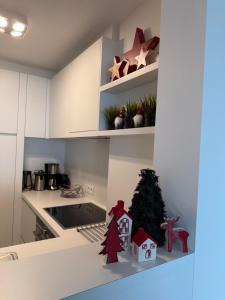 a kitchen with a christmas tree and decorations on a counter at Malouki Koksijde - 4 star appartment with magnificent sea view in Koksijde +40 photos