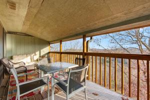 a porch with a table and chairs on a balcony at Ozark Overlook Escape - For 6 in Branson West
