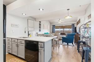 a kitchen with a sink and a dining room at Ozark Overlook Escape - For 6 in Branson West