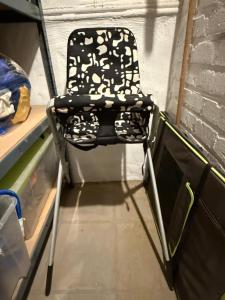 a black and white chair sitting in a room at Malouki Koksijde - 4 star appartment with magnificent sea view in Koksijde