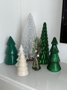 a group of green christmas trees on a shelf at Malouki Koksijde - 4 star appartment with magnificent sea view in Koksijde
