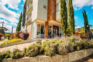 a building with plants in front of it at Augusta Centro Hotel in Canela