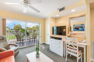 a living room with a desk and a television at Inn at the Beach-Venice FLORIDA in Venice