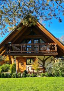 a house with a large deck on the front of it at Chata w Rabce - Bajkowa Osada in Rabka