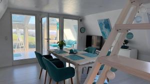 a dining room with a table and chairs at Villa Aurora in Waldbrunn